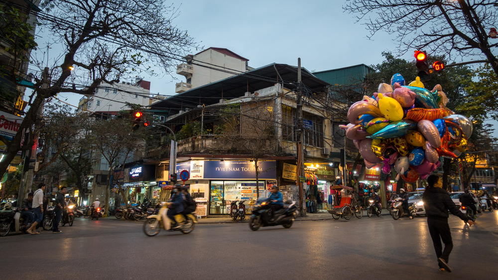 balloon seller standing in an intersection