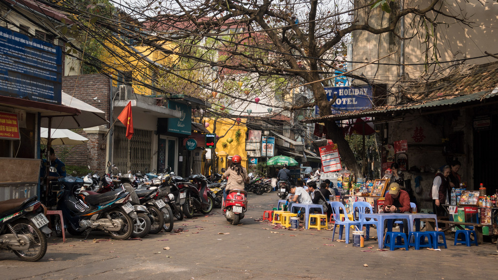 motorcyclist riding past a restaurant