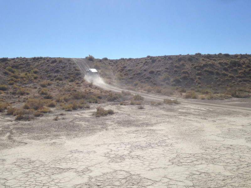 car climbing the slope and making a dust trail