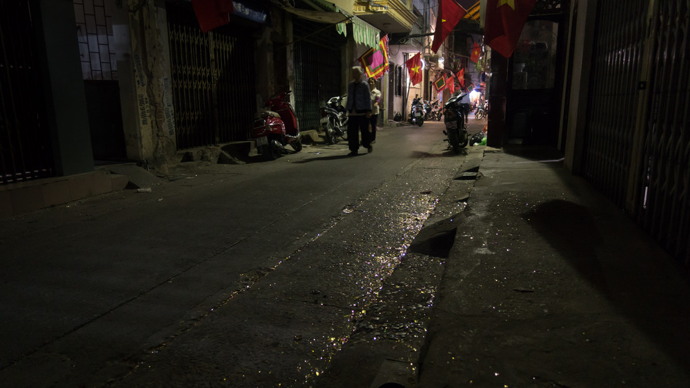 dark street covered in metallic confetti