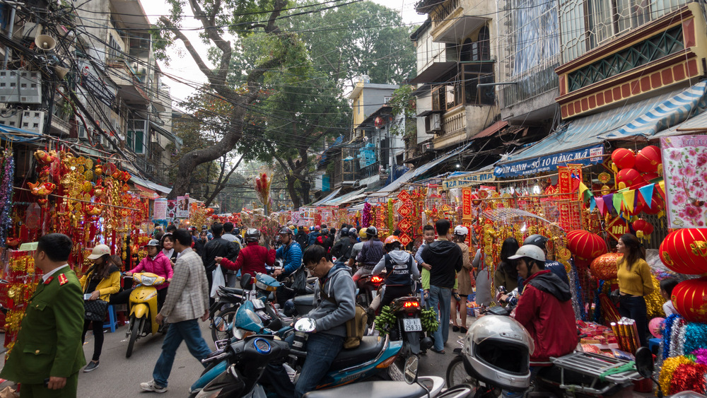 people shopping in the colorful Tet market