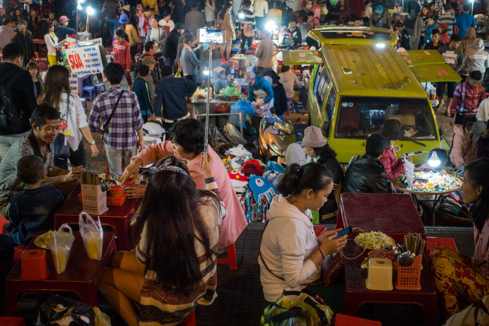 people eating in the crowded night market