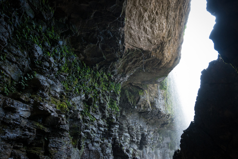 view of the waterfall from inside a cave