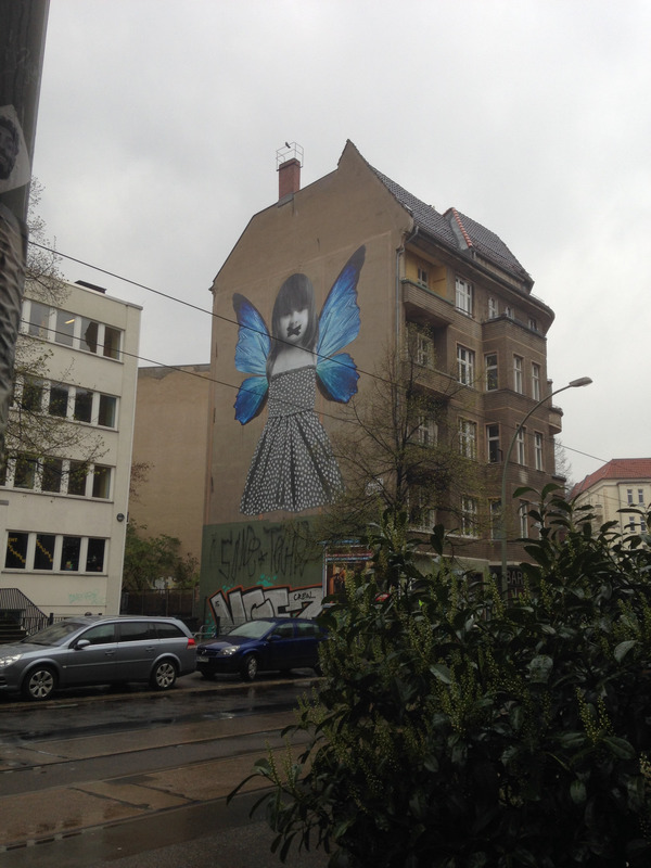 large image of a girl with wings plastered on a building