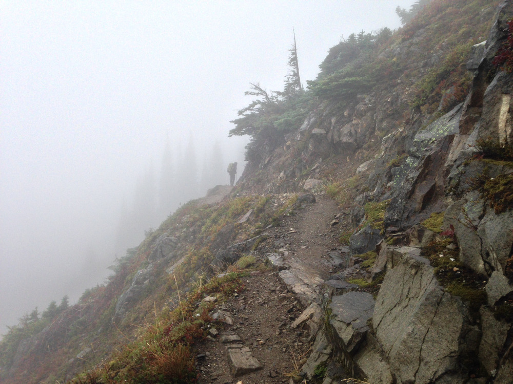 a backpacker on the steep trail