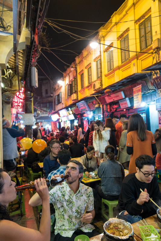 tourists eating and drinking on Food Street