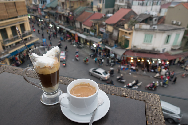 coffee perched on a rooftop table above the street