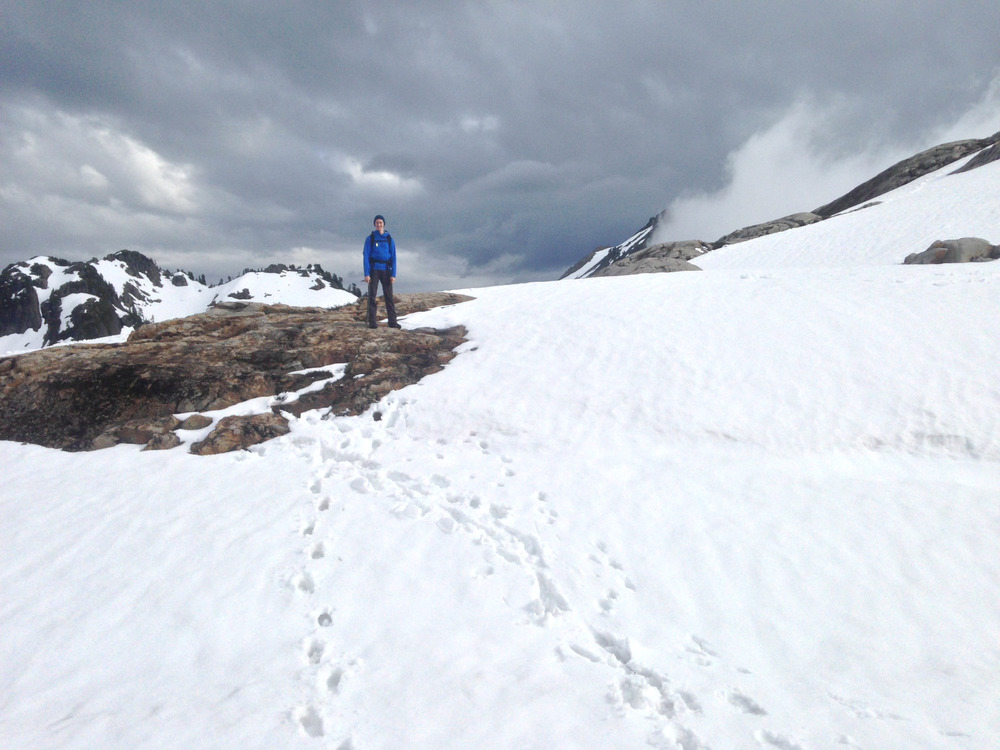 Jake standing on top of a snowy crest