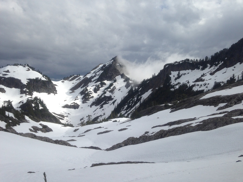 wisps of fog above the snow-covered mountains