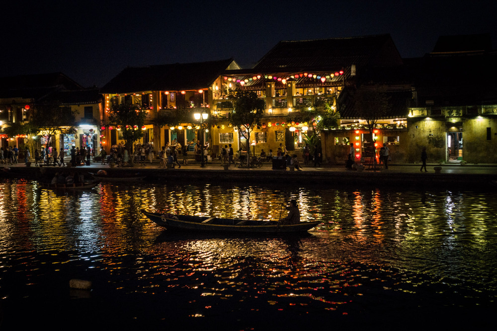 woman rowing a boat at night