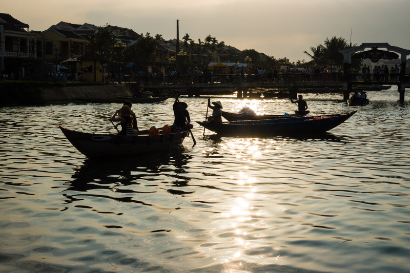 boats silhouetted against the sun's reflection