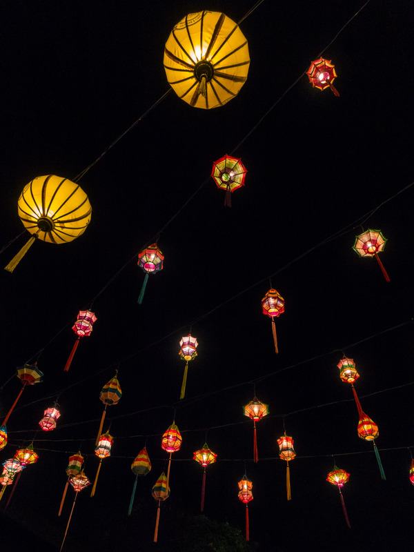 lanterns hanging above the street, seen from below