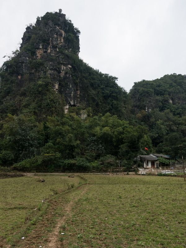 house below a rocky outcropping