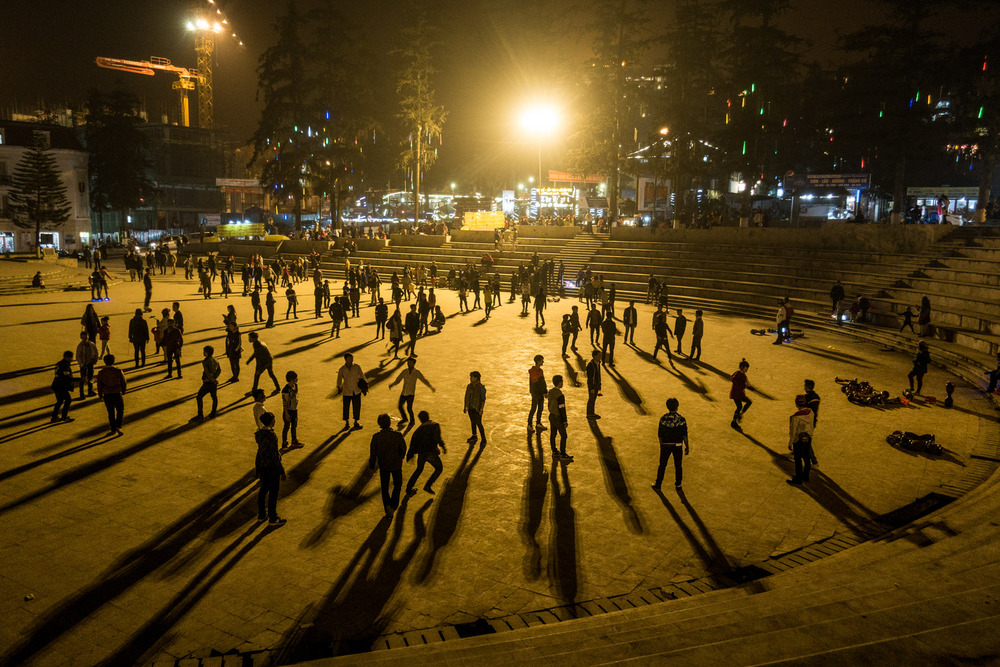 people playing in the square at night