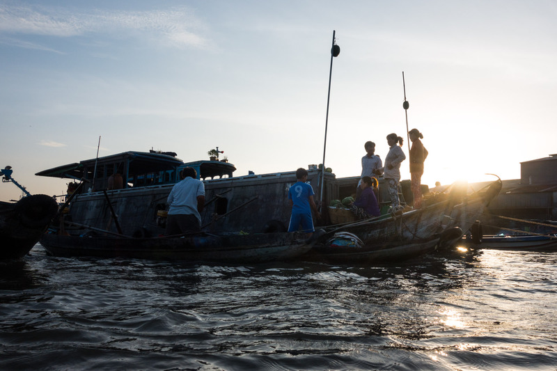 silhoutted boats in the market