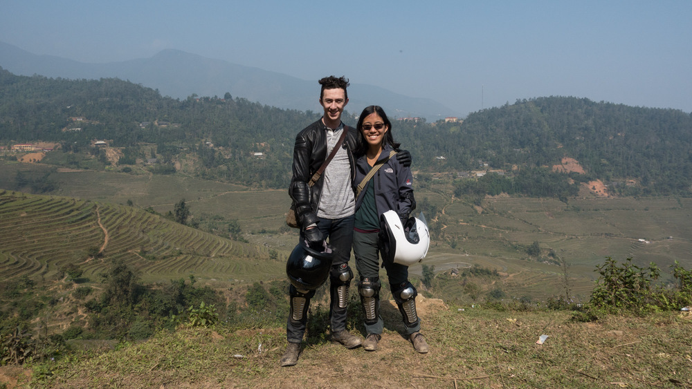 us, standing on a hillside with our helmets