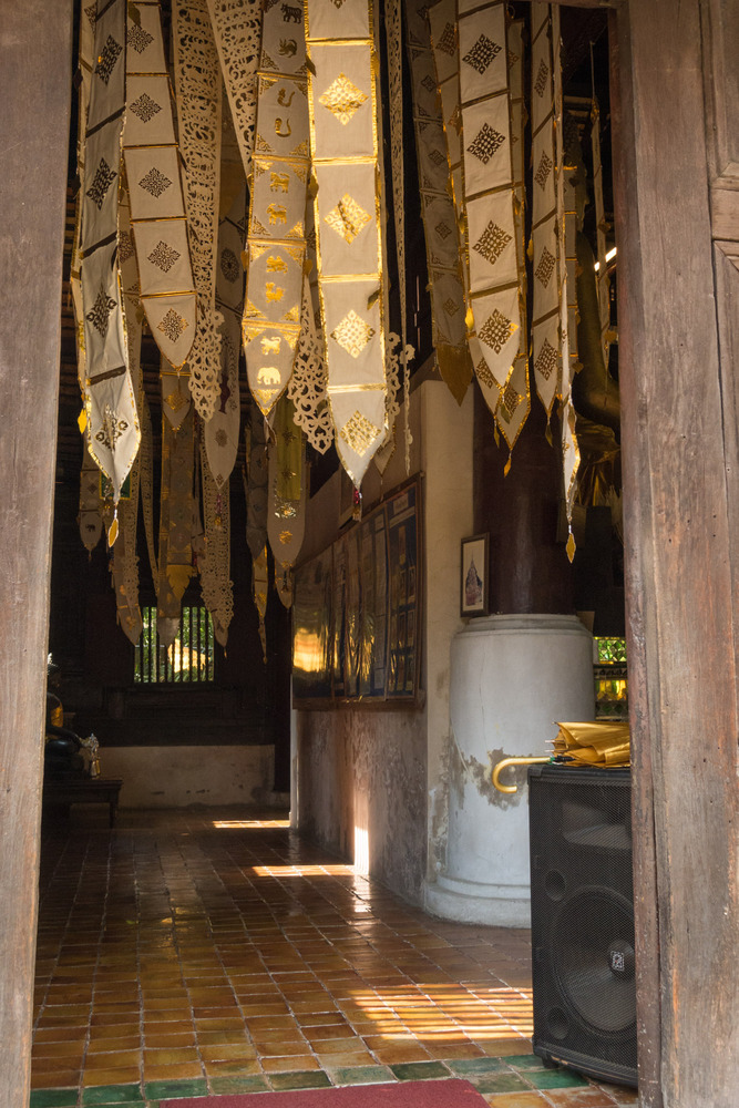 gold banners hanging inside a temple