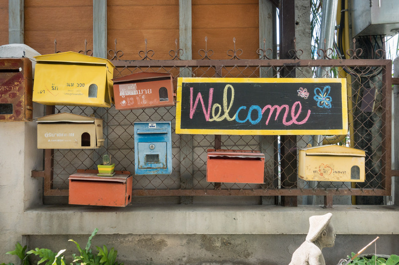 mailboxes and welcome sign on the wall