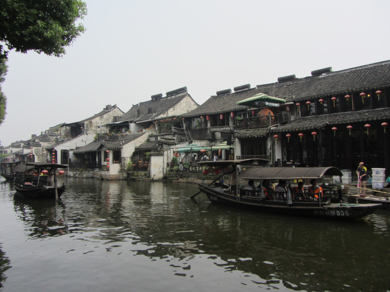 canal with boats and houses