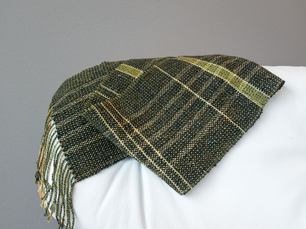 green scarf folded on a chair