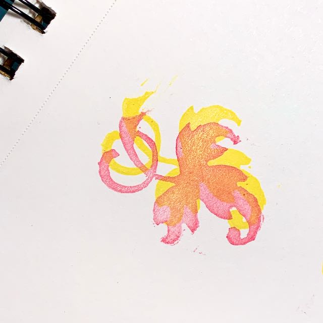 A hedera printed in overlapping pink and yellow ink on white paper.
