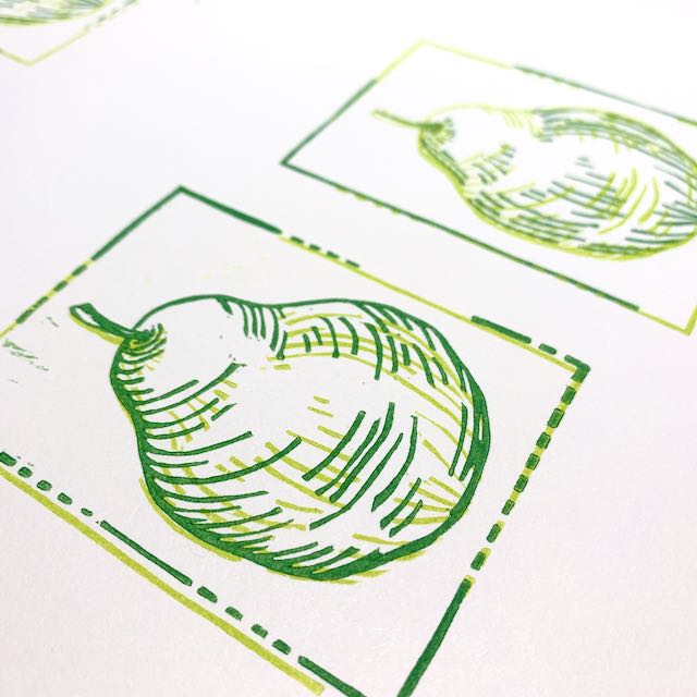 A print of two pears, depicted in light and dark green and viewed from an angle.