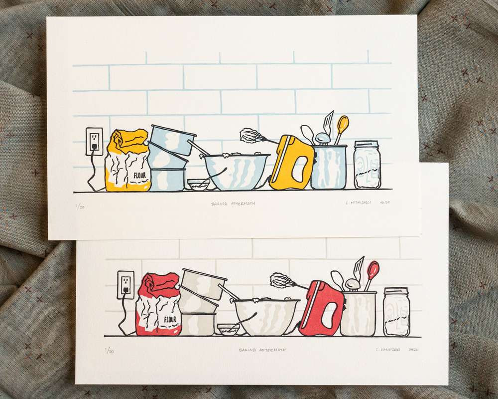 Two vibrantly colored baking-themed prints on white paper, overlapping. The top print has golden yellow appliances with baby blue shadows; the bottom print has red appliances with grey shadows.