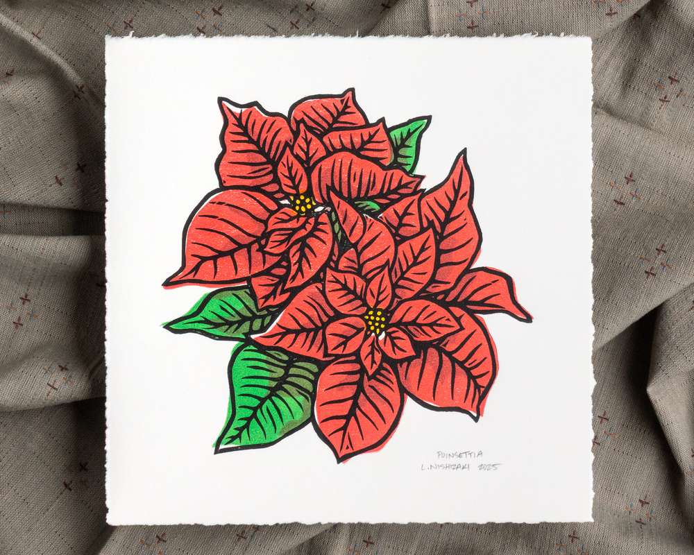 A red, green, yellow, and black blockprint of two poinsettia flowers on square white paper with torn edges.