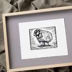 The print lying on grey matboard within a pale wood frame.