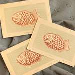 Three taiyaki prints, haphazardly overlapped. The three prints display slightly different print registration.